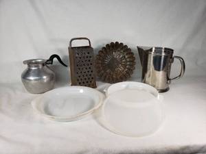 Vintage kitchenware including Glasbake and Tupperware dishes, ABCO aluminum pitcher, Vollrath stainless steel pitcher, and a metal grater with mold pan