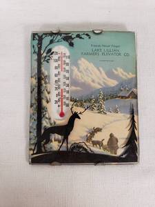 Lake Lillian Farmers Elevator Co. Vintage Thermometer Plaque features a scenic winter landscape with a silhouette of a deer and a person with sled dogs