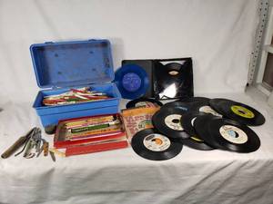 Assorted vintage items including 45 RPM vinyl records, pencils, and tools