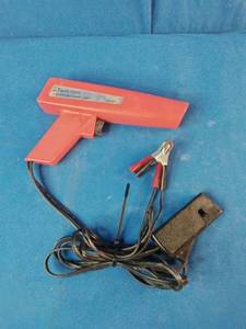 Sunpro Actron CP7504 inductive timing light, used for precise engine timing adjustments.