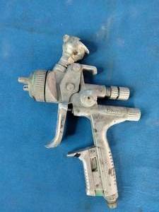 SATAjet 5000 B HVLP spray gun, featuring a compact design with a prominent 1.3mm nozzle and green accent ring.