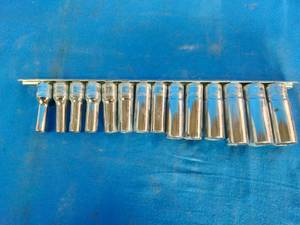 Metric Mac Tools set of deep sockets arranged on a metal storage rail