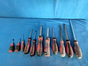 Mac Tools screwdrivers with red and black handles.