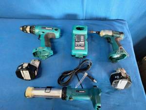 Makita 6337D 14.4V cordless tool set featuring teal-colored drills and a matching charger.