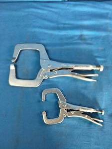 Mac Tools brand locking C-clamps used for securing workpieces.