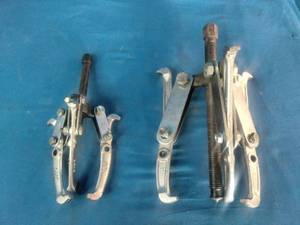 (2) 3-jaw gear pullers used for removing gears, pulleys, and pressed-on components.