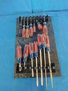 Craftsman acetate-handle screwdrivers mounted on a storage rack organizer.