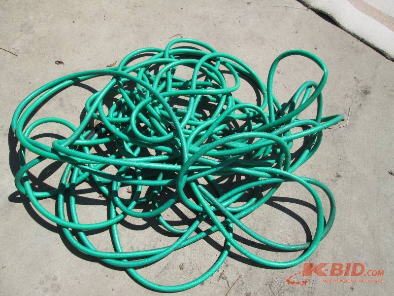 lot 76 image: Long garden hose in good condition...
