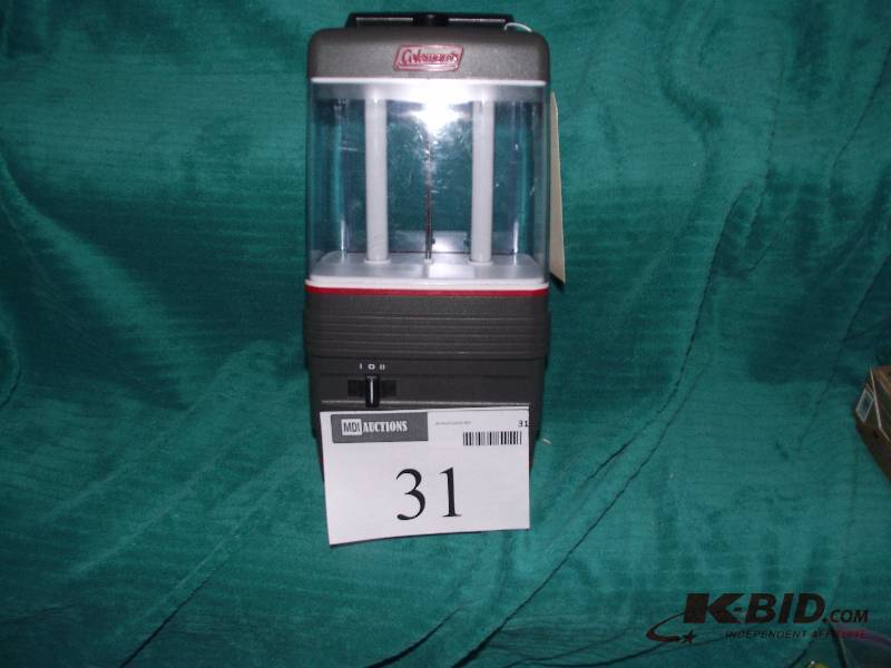 lot 31 image: Coleman battery operated florescent light.  2 brightness settings and an adjustable rear reflector for lighting 180 to 360 degrees.  Works will demonstrate.