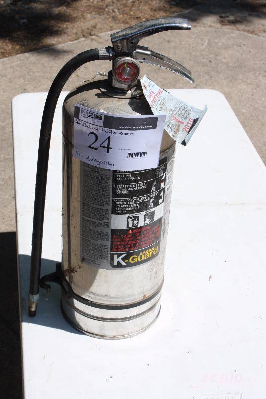 lot 24 image: K-Guard Fire Extinguisher Metal WHose Last Serviced 2010 Needs Re-Charging.