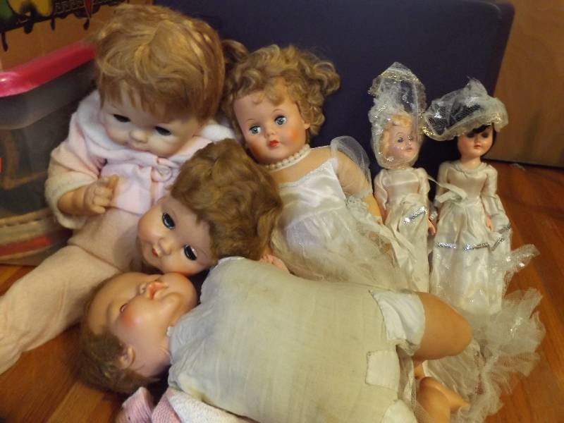 Three wedding dolls, two baby dolls...