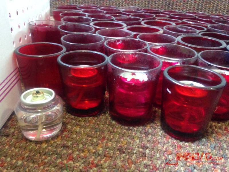 lot 12 image: Bulk lot of (67) red and (9) blue votive cand...