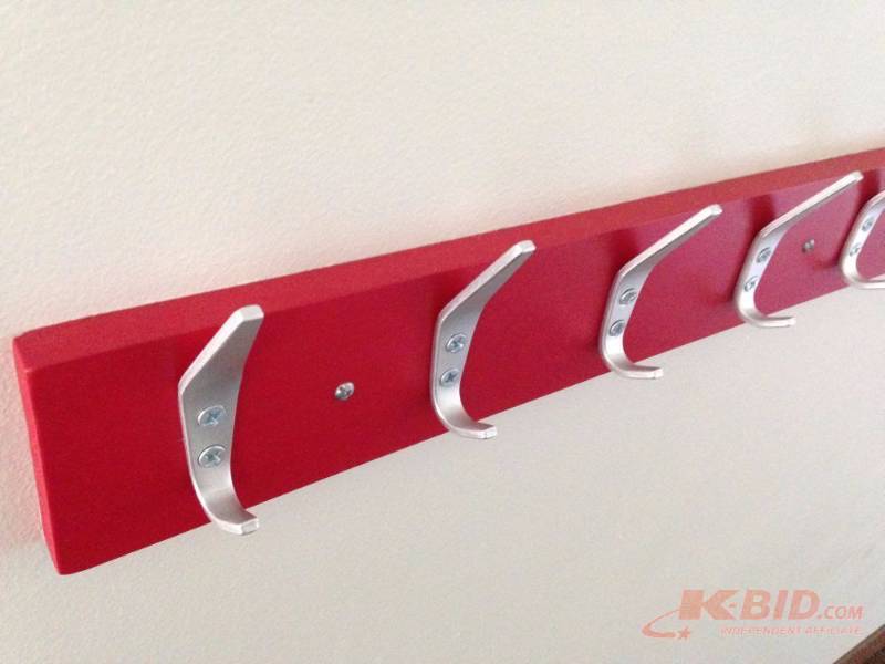 lot 63 image: Pine coat rack painted red. Measures 32in wid...