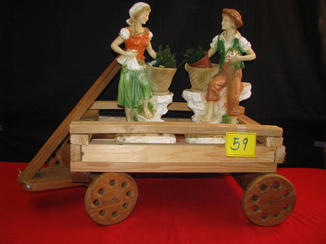 small cart and two plaster figurines
