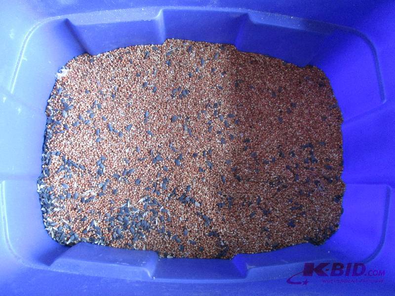 Large plastic tub of bird seed, lik...