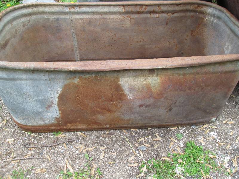 Metal stock tank, bottom is rusted ...
