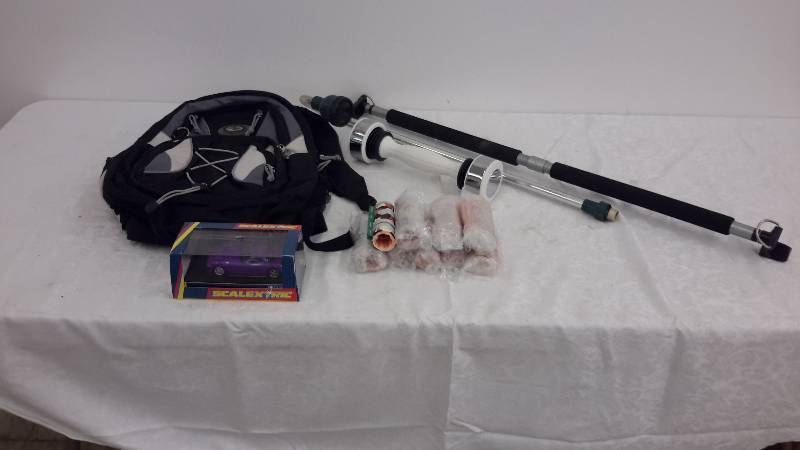lot 88 image: shake weight, model car, garden sprinkler, bar, bag