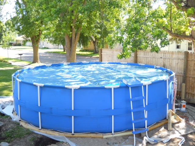 lot 1 image: Above Ground Pool - 18 Intex  with solar cover and pump. Includes some accessories