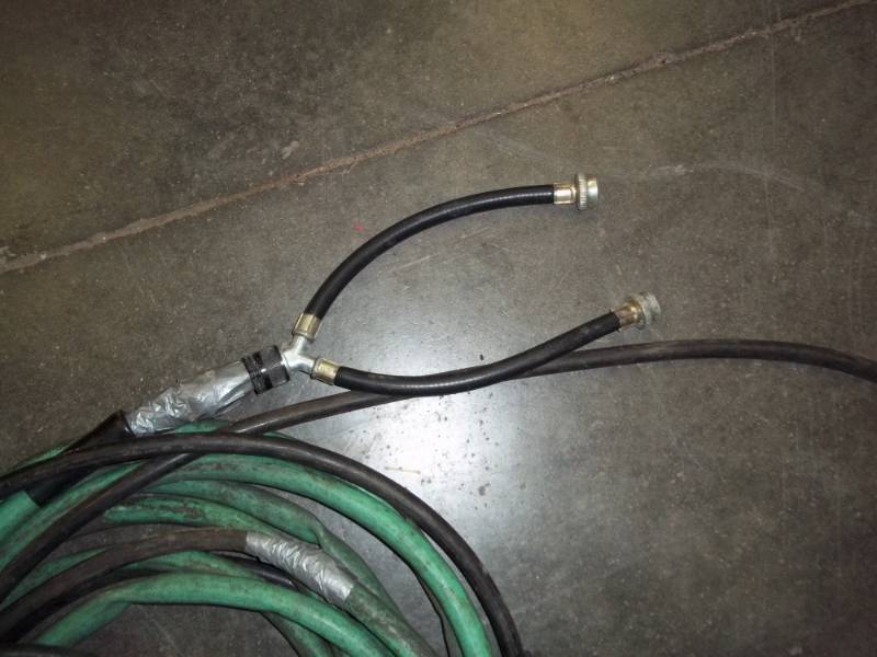 lot 103 image: Cabin  House Winterize for water lines, hose set up to connect to washing machine and to air tank for blow out of water.