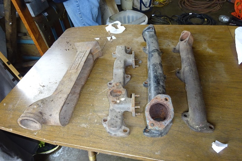 lot 187 image: Flat head exhaust manifolds and a model a heater