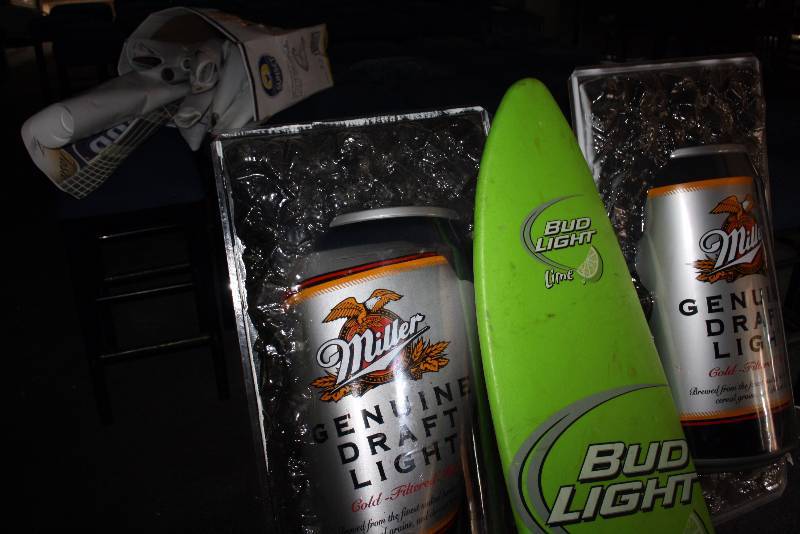 lot 50 image: Lot of (4) Decorations Including Bud Light Surf Board MGD Light Displays Box Of Posters.