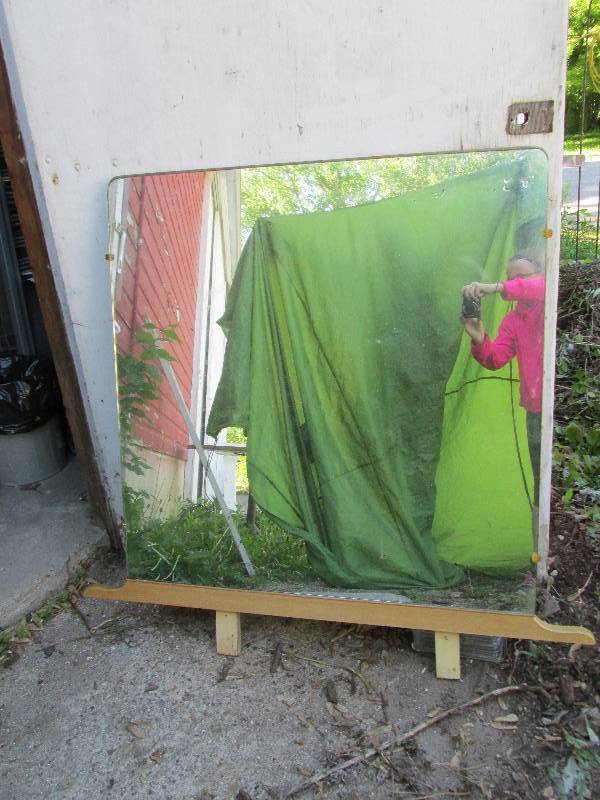 Thick vintage mirror mounted on woo...