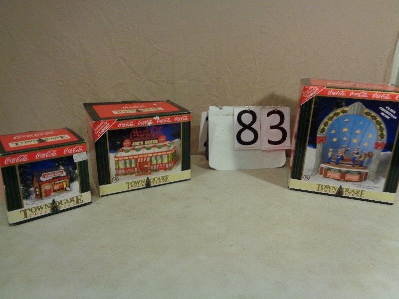 lot 83 image: Coca Cola Light Up Porcelain Christmas Collector Houses