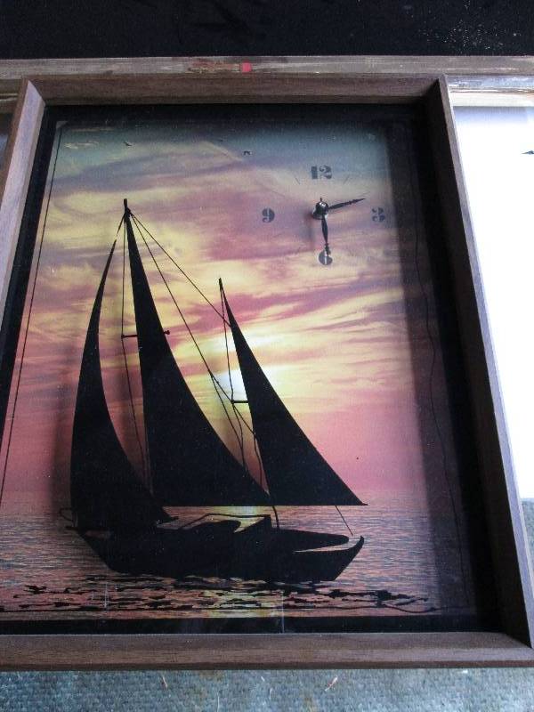 Framed glass encased clock with boa...