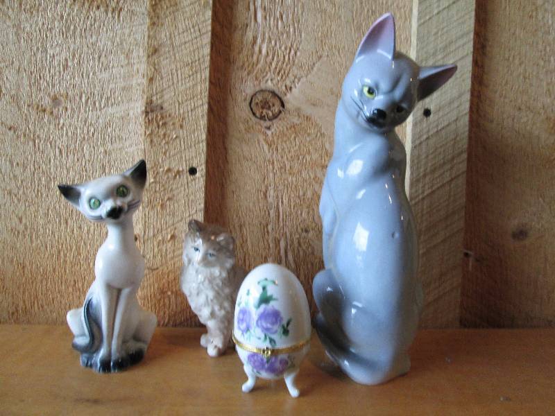 3 cats and a porcelain egg with gla...
