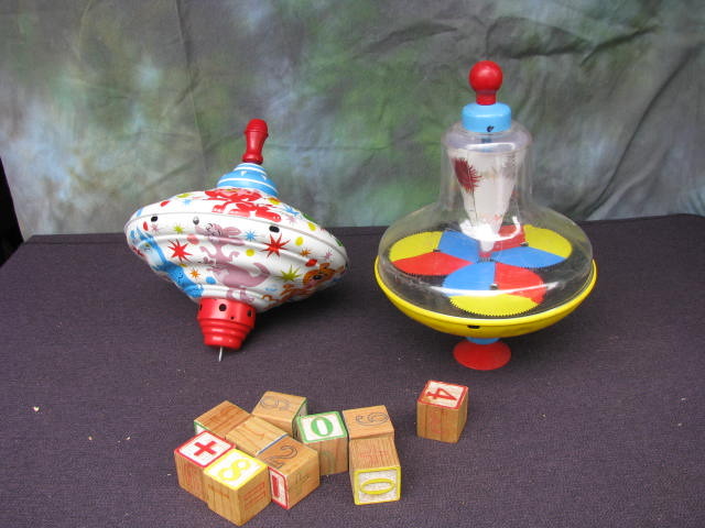 alphabet blocks and two spinning tops