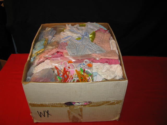 very large box filled with doll clothes and doll blankets