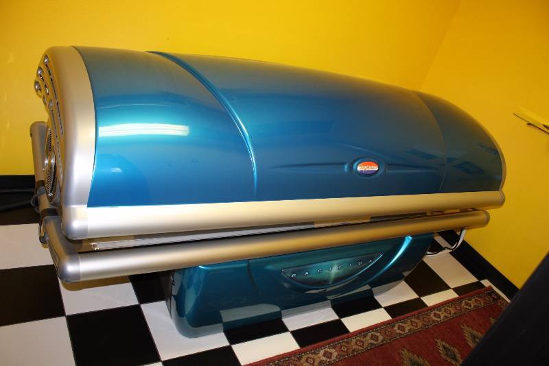lot 5 image: Room Lot Including Tan America Pacifica Tanning Booth, 4387 Hours Canopy Style Curved WCords Dimensions Tanning Bed 89 x 47 x 40 Decorative Floor RunnerRug, 84 x 24. Glass Shelf 18 x 6 Wall Mount Garbage Can 14 x 7 x4