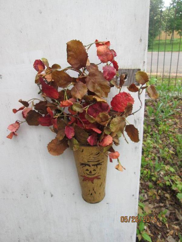 lot 21 image: Hanging metal vase with scarecrow d...
