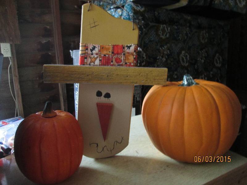 lot 149 image: Fall pumpkins paired with a scarecr...
