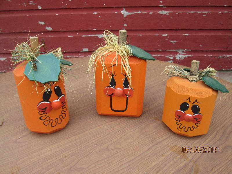 Trio of smililng wooden pumpkins ...