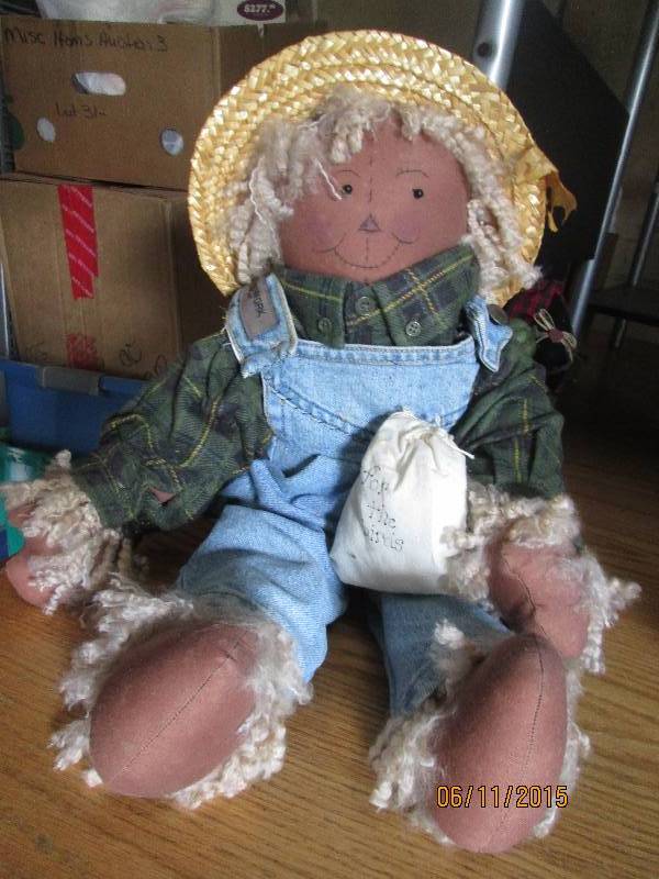 Plush scarecrow with a bag of birds...
