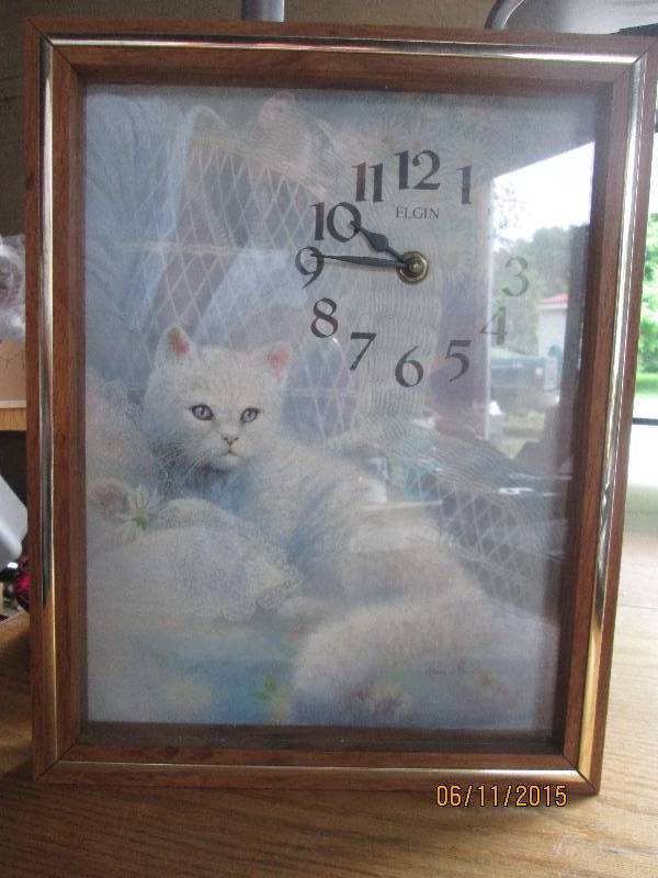 Clock with print of a cat in a wick...