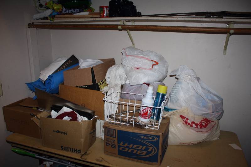 lot 35 image: Table & Shelf Lot Including Candles wGlass Containers Drain wPVC Attachment Box of Plastic Cups And More.