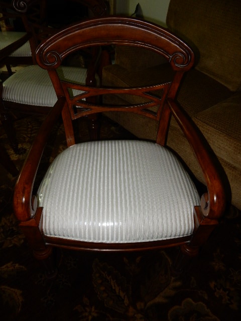 4 Solid wood dining room chairs.. Dark wood finish and nice upholstery