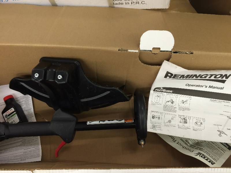 lot 58 image: Brand new  Remington 41BD160G983 Rustler 17-Inch 25cc 2-Cycle Straight Shaft Gas Trimmer with QuickStart Technology retail  $109