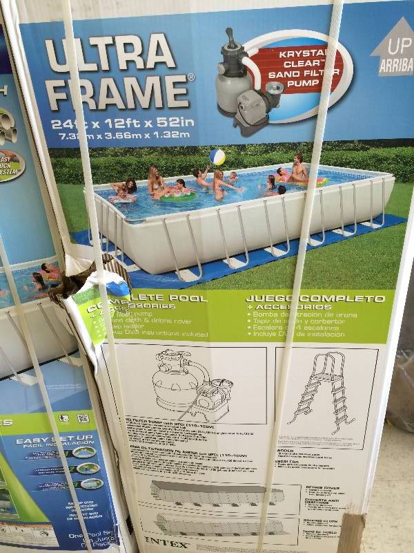 lot 95 image: Brand new Intex 24ft X 12ft X 52in Ultra Frame Pool Set retails for $1,200