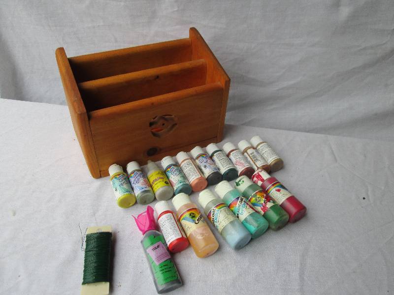 Craft paint and supplies in a wood ...