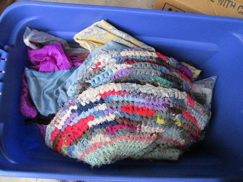 Plastic bin filled with cloth and m...