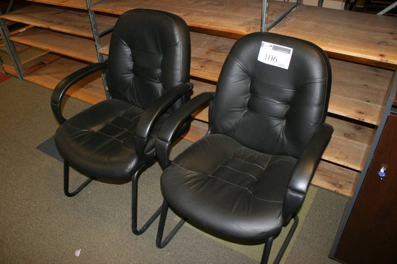 lot 106 image: Lot of (2) Leather Style Chairs wArm Rests Plastic Frames Black.