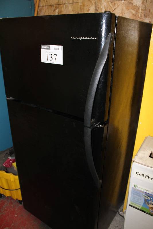 lot 137 image: Frigidaire Refrigerator & Freezer wIce Maker & Storage On Door & Base Model AD-18 Black 29.5 x 30 x 66 Contents Not Included.