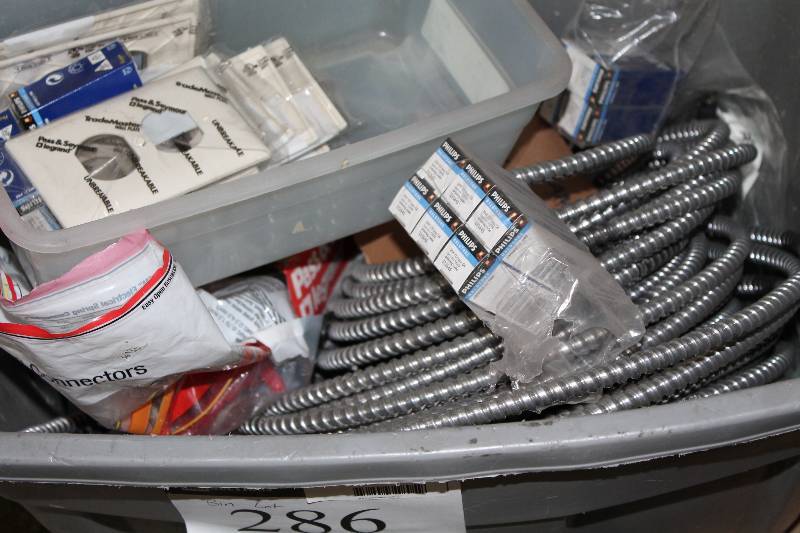 lot 286 image: Bin Lot Including Outlet Covers Wire Cable wMetal Housing Philips Halogen Bulbs And More.
