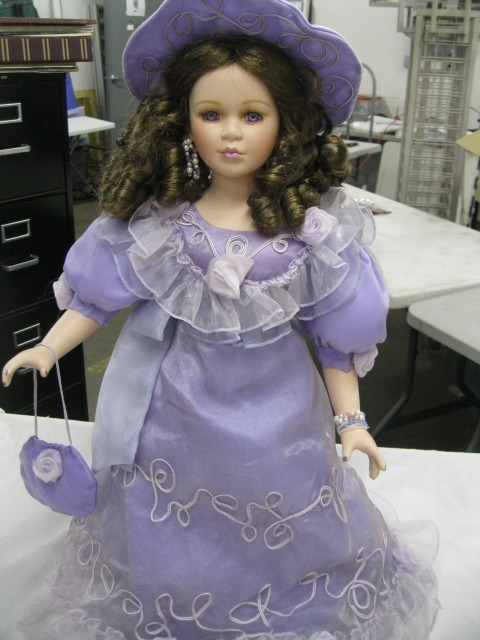 Porcelain doll on stand