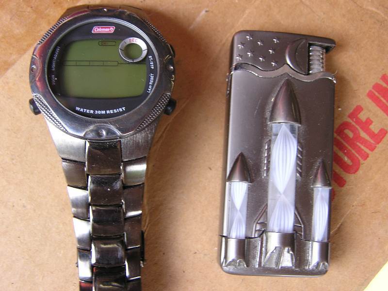 lot 68 image: COLEMAN DIGITAL WATCH AND BUTANE LIGHTER