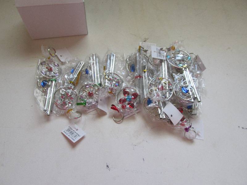 lot 105 image: 12 windchimes new in box...
