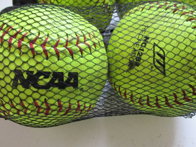 lot 155 image: 4 softballs with drawstring net ...